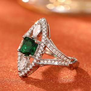 Macro side view of marquise cut emerald green ring with micro-pave zircon detailing