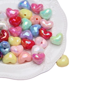 Rainbow heart beads on white ceramic tray for DIY jewelry and phone chains