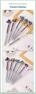 Detailed shot of assorted silver metal pens filled with natural crystal raw stones