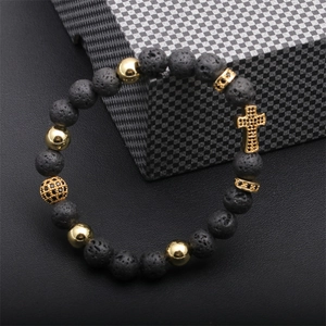 Detail of lava rock beads with gold accents and a micro-pave zircon cross charm