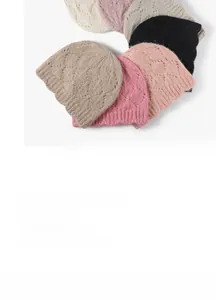 Detailed close-up of chunky knit beanies showing ribbed cuffs and diamond patterns