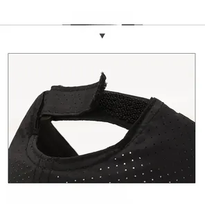 Detail view of the breathable laser-cut holes and adjustable velcro strap on black sun hat