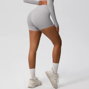 Close-up of light gray yoga shorts featuring high-waisted lifting and body-sculpting fit