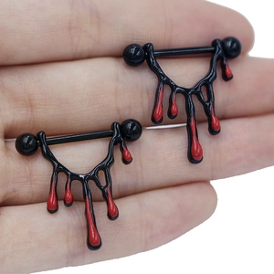 A pair of stainless steel nipple rings with black metal finish and red drip design