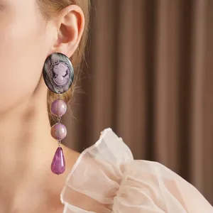 Vintage cameo portrait drop earrings with purple beads in a retro aesthetic style