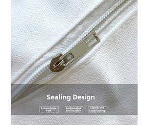 Close-up of silver metal zipper closure on white canvas tote bag showing stitching