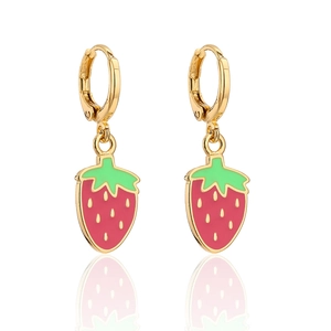 Macro view of 18K gold plated strawberry earrings with vibrant red enamel and green leaves