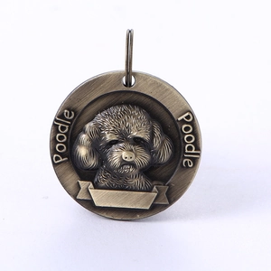 Macro detail of bronze poodle pet tag with 3D relief carving and engraved text banner