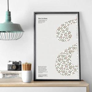 Framed Christmas art print with holly leaf typography in a minimalist home office setting