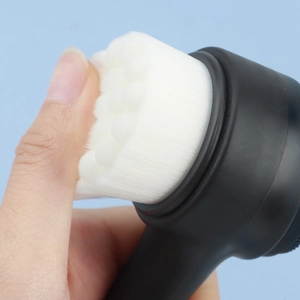 Close-up showing the soft white fiber bristles and flexible elasticity of the facial brush