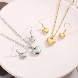 Détail de parures de collier avec pendentif cœur en argent et or avec boucles d'oreilles