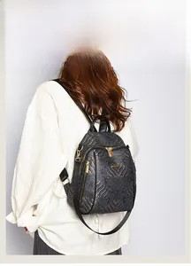 Detail of Chinese style backpack with golden wave embroidery and metallic gold zippers