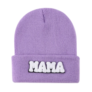 Close-up of lilac knitted beanie with white MAMA towel embroidery on the fold