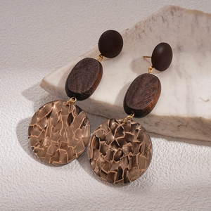 Detail view of vintage geometric wood earrings with marble texture and golden accents