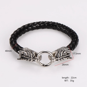 Detailed view of woven leather bracelet with wolf head charms and size dimensions