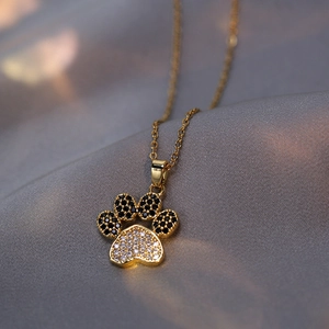 Golden heart-shaped cat paw pendant necklace with red and white sparkling zircon stones