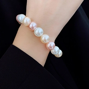 Detailed view of multi-color pearls bracelet featuring white, pink and champagne tones