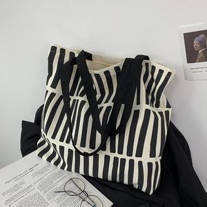 Detail of minimalist black and white striped canvas tote bag with large capacity