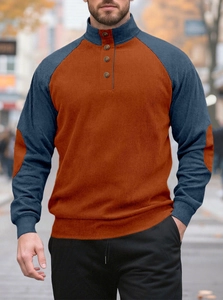 Detail of color-block knit shirt showing buttoned stand collar and ribbed fabric texture