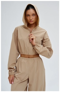 Detailed macro view of the khaki hooded sports jacket showing zipper and fabric texture