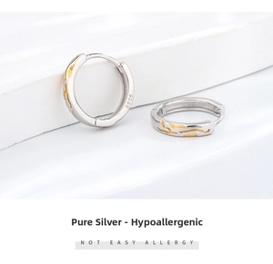 Detail of S925 sterling silver earrings with gold texture and hypoallergenic stamp