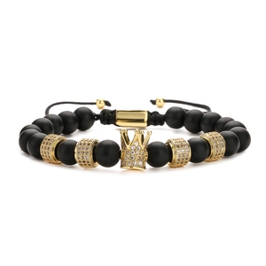 Men's matte black beaded bracelet with gold micro-pave crown and adjustable closure