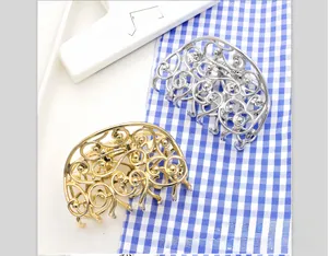 Detailed view of elegant hollow butterfly hair claws in vintage gold and silver finishes