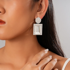 Orecchini geometrici in argento con cristalli rettangolari e diamanti su modella