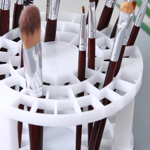 White circular makeup brush holder with multiple holes for desk organization