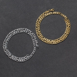 Detail of 5mm Figaro chain necklaces in gold and silver finish with lobster clasp closures