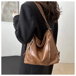 Dettagli della trama della borsa tote in pelle PU marrone e cerniere laterali
