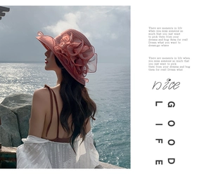 Detail of pink wide brim sun hat with organza floral decoration for outdoor beach wear