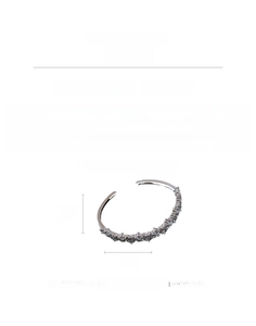 Detail view of silver zircon open bangle made of copper showing 11.6g weight and size