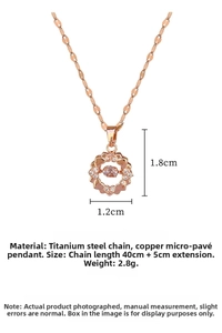 Macro shot of rose gold circle pendant with pink center stone and white cubic zirconia