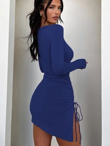 Detail view of navy blue mini dress featuring side drawstring ruching and slit design