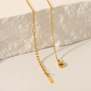 Macro shot of 18K gold plated stainless steel necklace clasp and S.STEEL hallmark