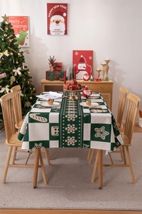Green and white plaid Christmas tablecloth with snowflakes and gingerbread man patterns