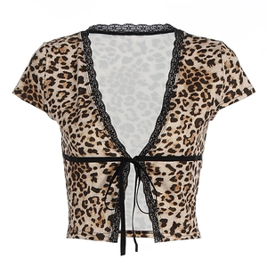 Detailed view of leopard print cropped top with black lace trim and front tie closure
