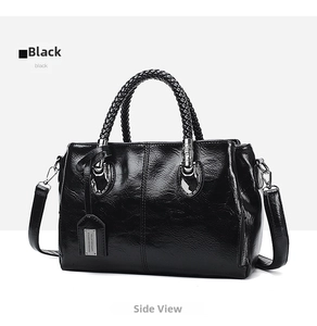 Detail of vintage black oil wax leather boston bag with woven handles and metal hardware