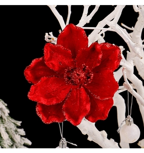 Macro detail of red velvet Christmas flower with glitter edges and silver hanging cord