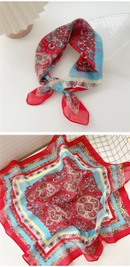 Detail of red and blue paisley cotton linen square scarf as neckerchief and headwrap