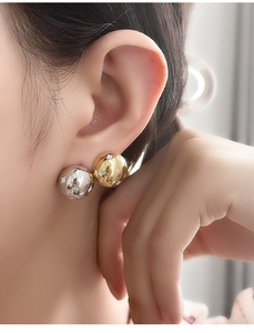 Detail of S925 sterling silver sphere stud earrings with star engraving and cubic zirconia