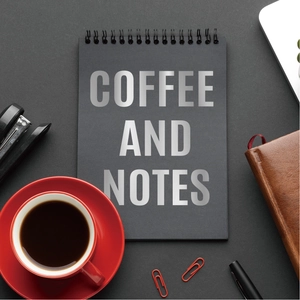 Close-up of a minimalist black spiral notebook with COFFEE AND NOTES silver lettering