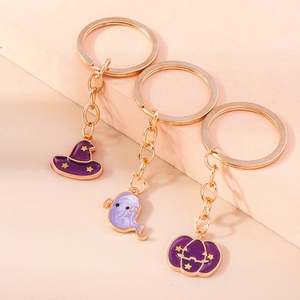 Detailed view of Halloween keychains featuring purple enamel witch hat ghost and pumpkin charms