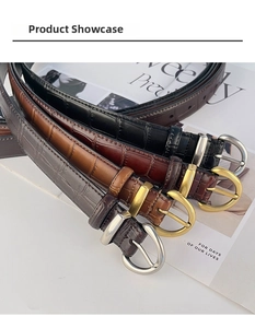 Detail of crocodile embossed leather belts for women with stylish D-shaped metal buckles