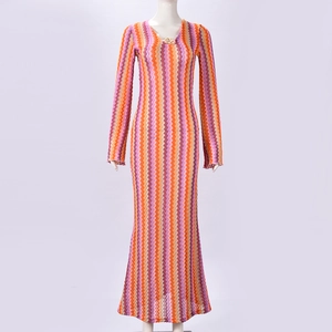 Detail of V-neck with metal ring on zigzag patterned slim long-sleeved dress