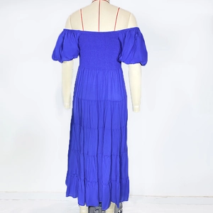 Detail of royal blue shirred bust and tiered skirt structure on a back view dress