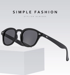 Retro round black sunglasses shown on a minimalist stone display stand with UV lenses