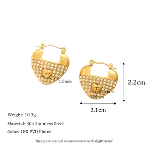 Detail view of heart-shaped gold earrings with pearl accents and technical dimensions