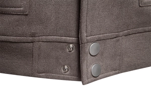 Détails de l'ourlet de veste en daim marron avec boutons-pression en métal et bordure côtelée